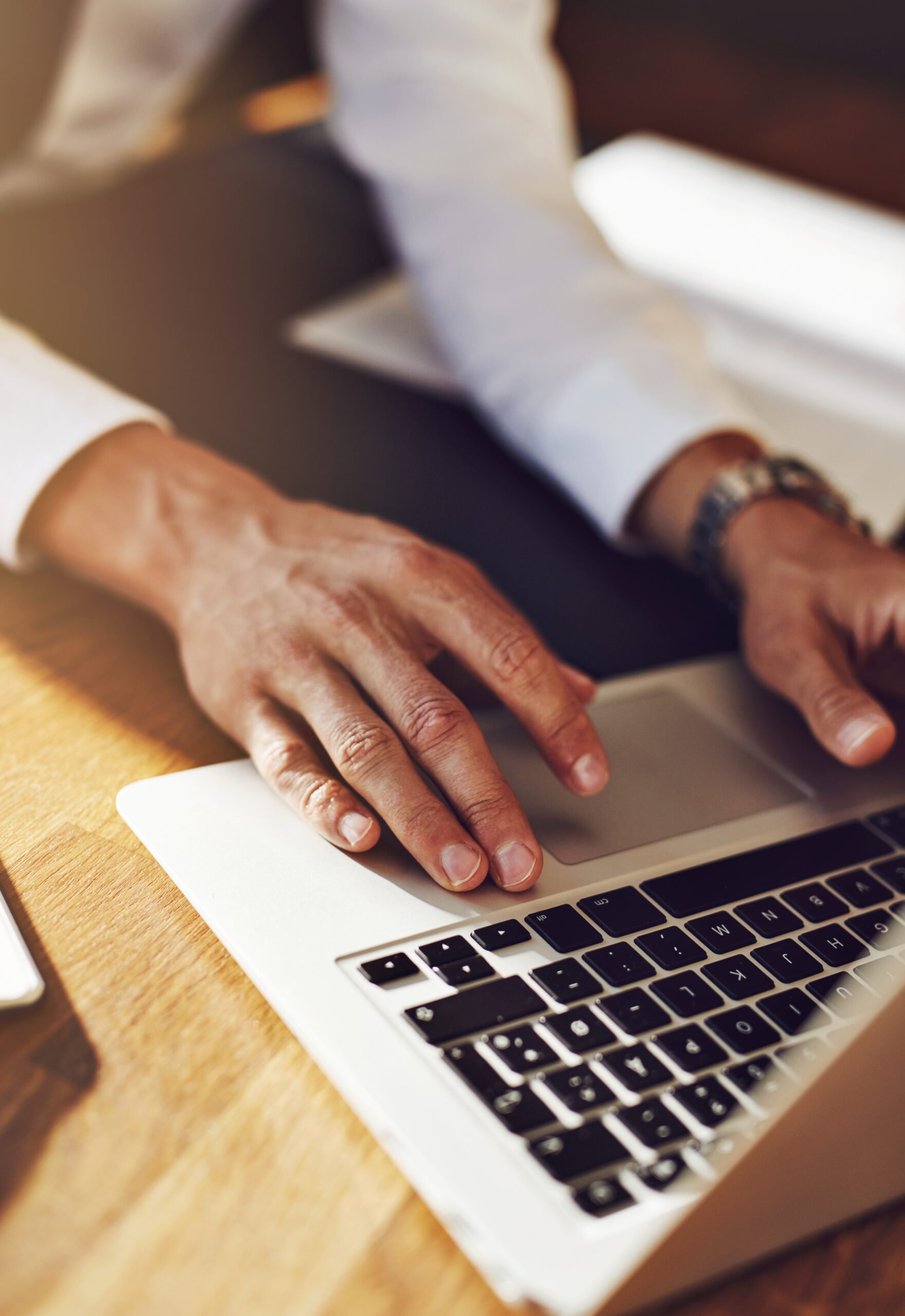 Working on laptop, close up of business man