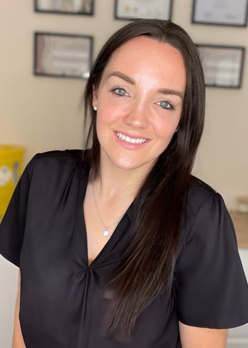 Photo of woman looking at the camera, smiling.