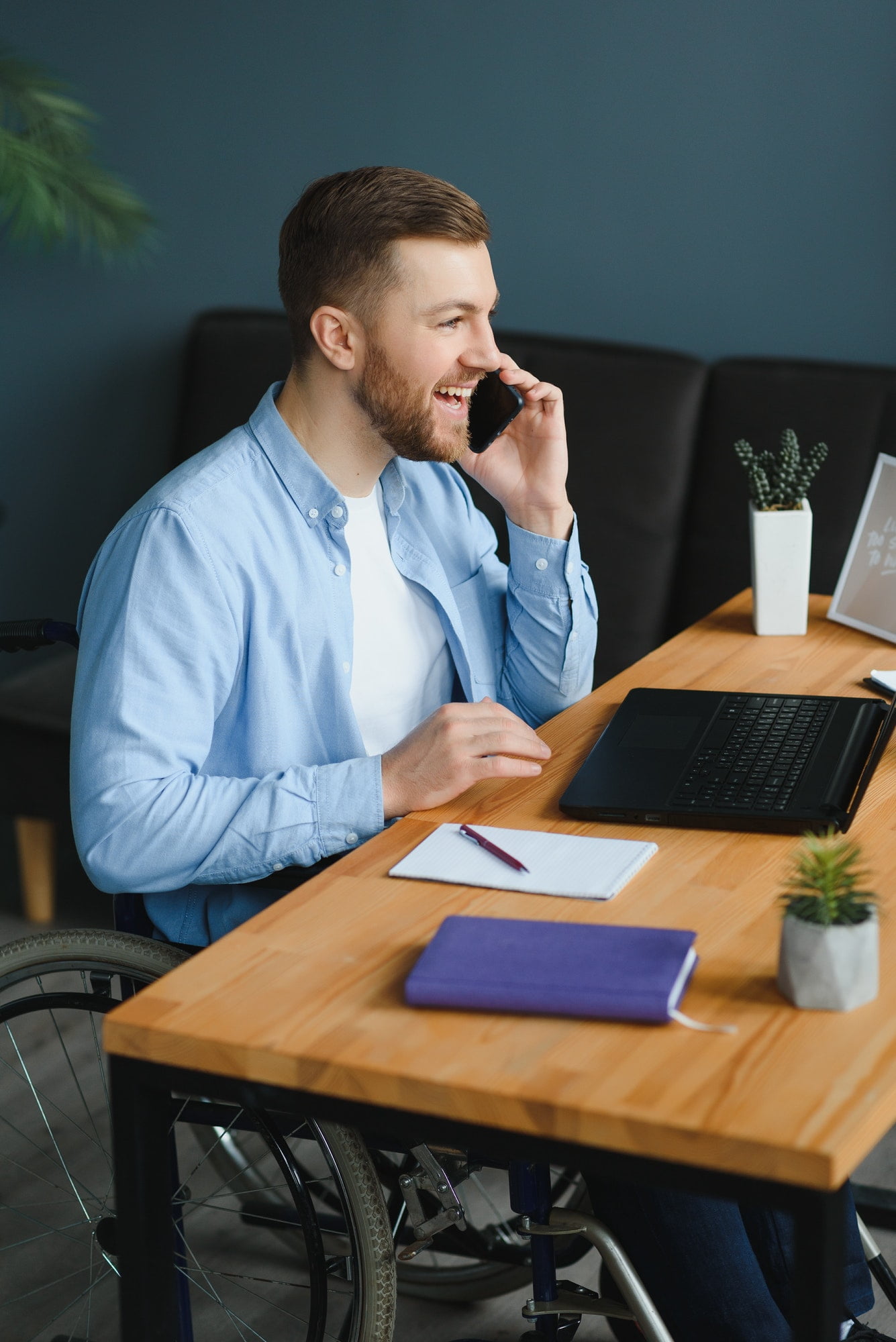 Male working from home, talking on the phone