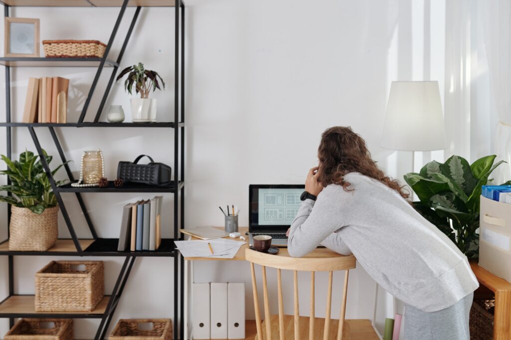 Female working from home in office talking on the phone