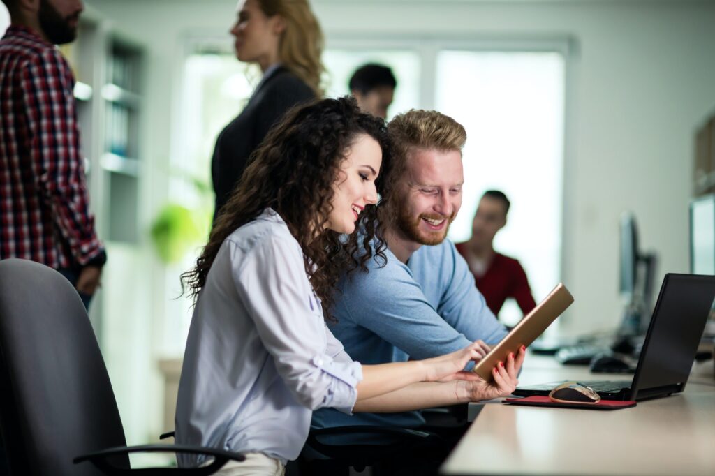 A male and female discussing IT issues in an office