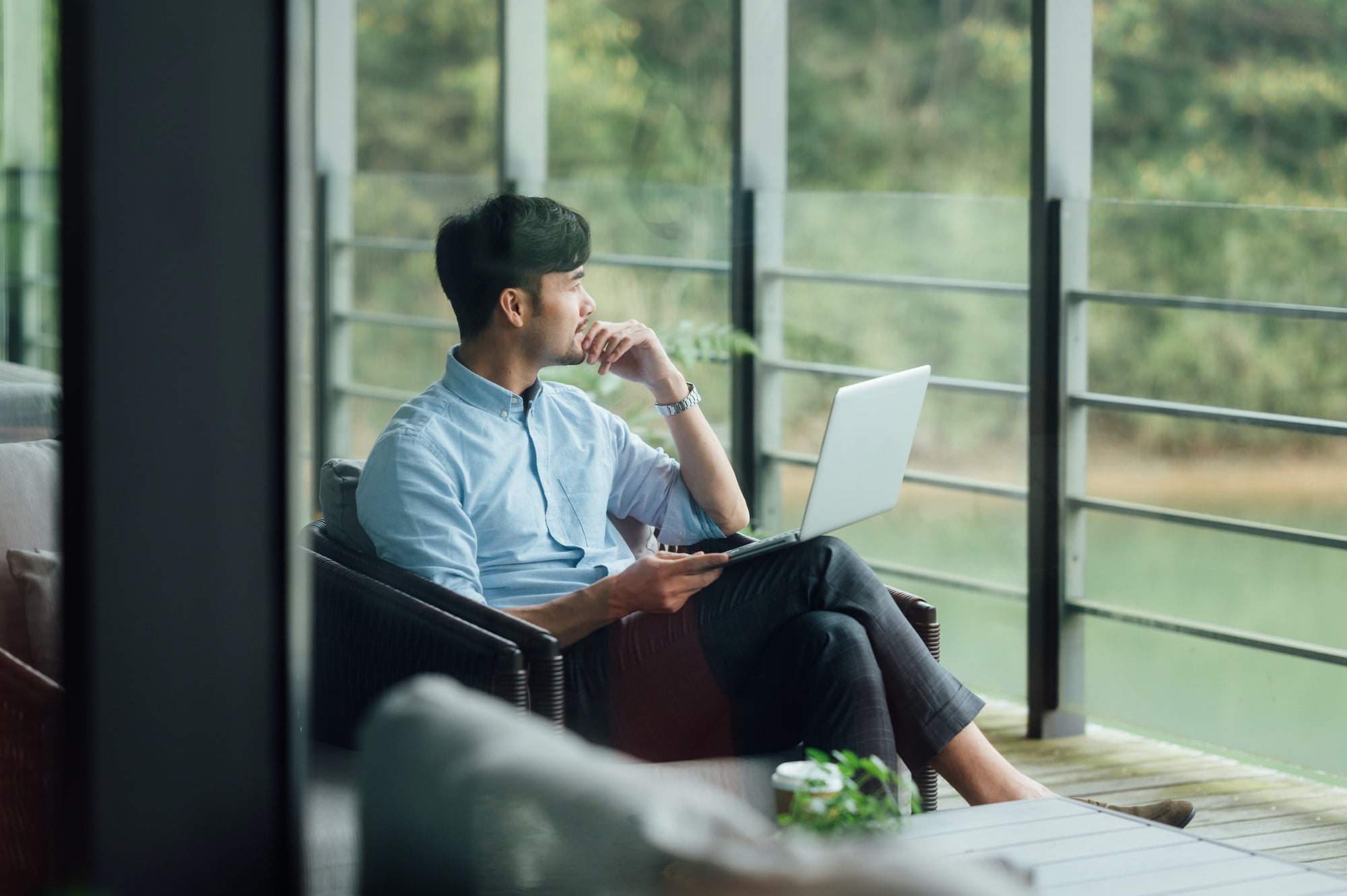 Man sat by window with laptop