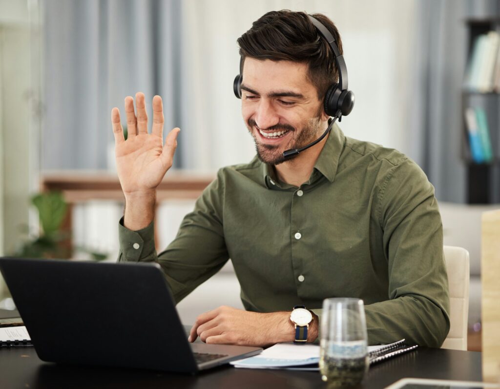 Man on a video call wearing headset with laptop
